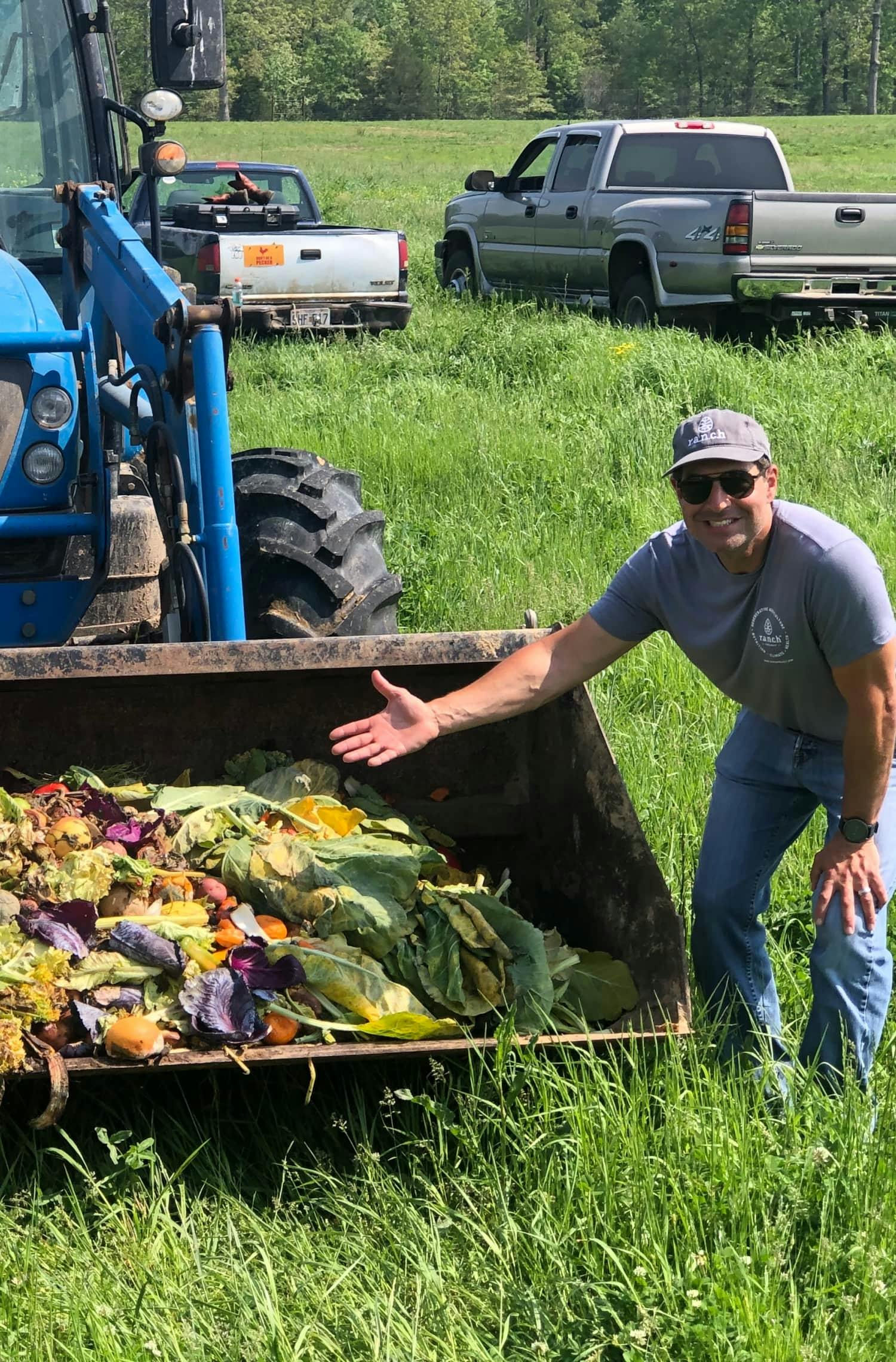 Jordan Rubin in front of a tractor full of food