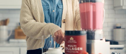 woman making smoothie with multi collagen protein